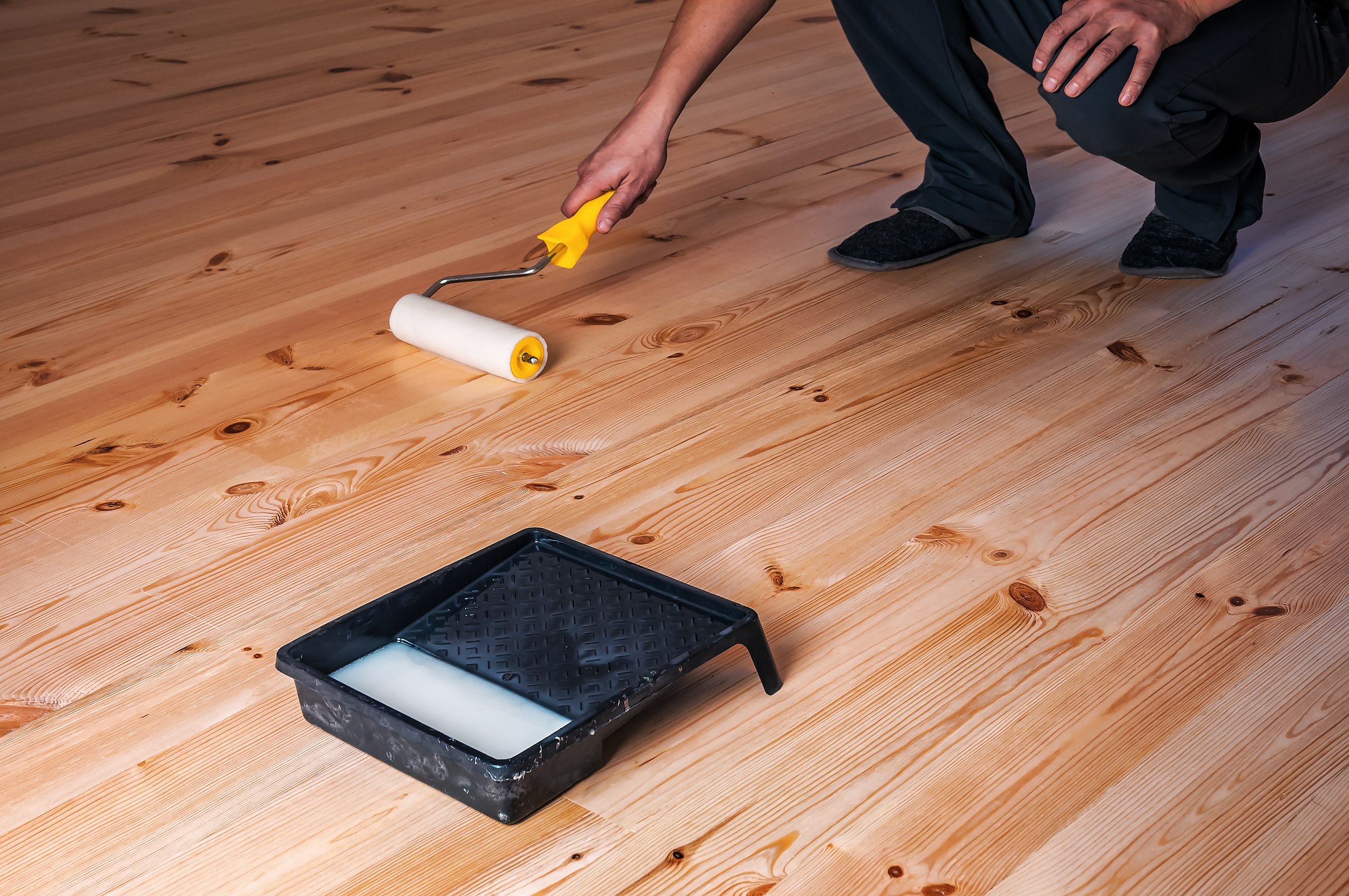 Eco-Friendly Wood Floor Sanding in London – Isleworth wide-plank pine floorboards being finished with a low-VOC roller application after dust-free sanding.