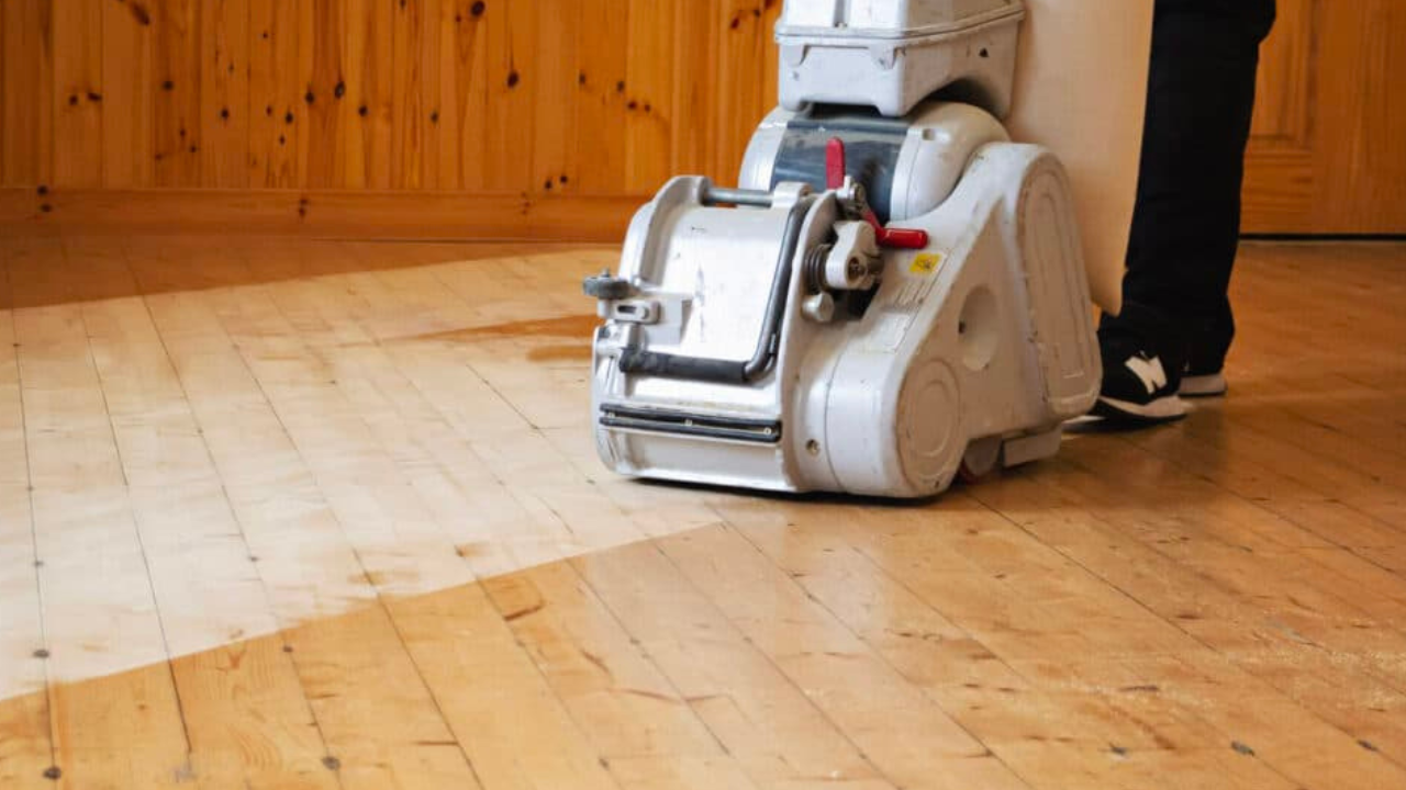 Eco-Friendly Wood Floor Sanding in London – Isleworth solid pine floorboards midway through restoration with an efficient, low-dust belt sander.