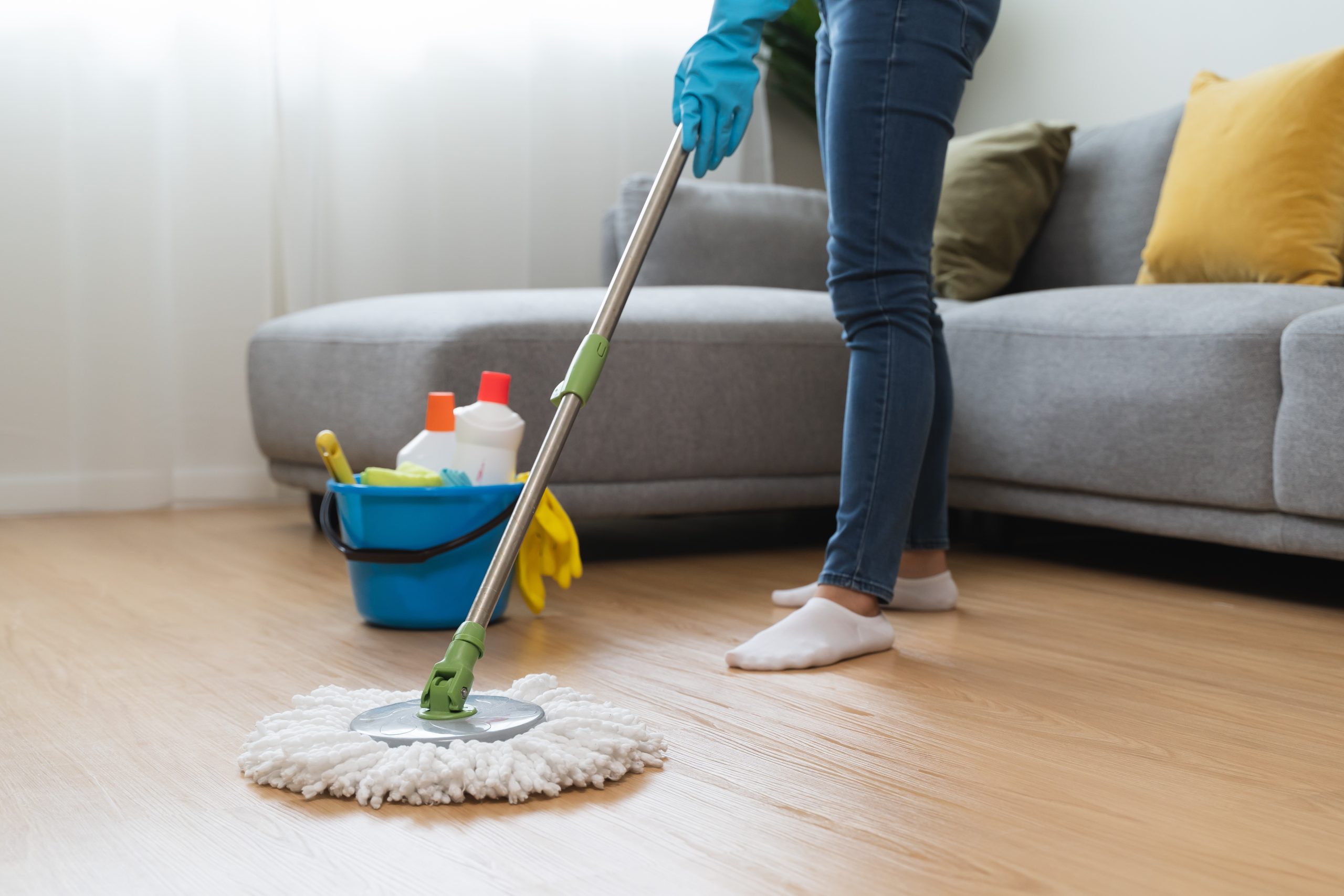 Homeowner mopping a newly restored oak wood floor after Transforming Victorian Boards, maintaining the revitalised Victorian boards.