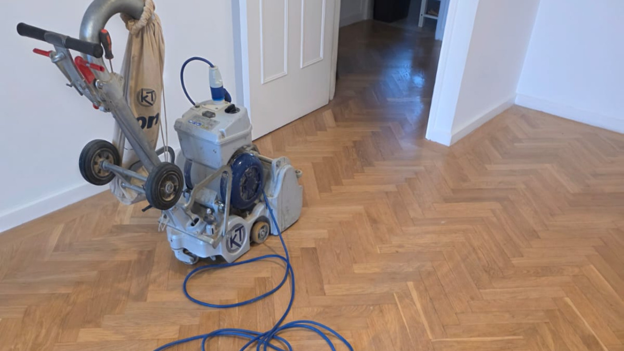 Parquet Floor Sanding in Isleworth on an oak herringbone parquet floor with a professional drum sander in a freshly refurbished living area.